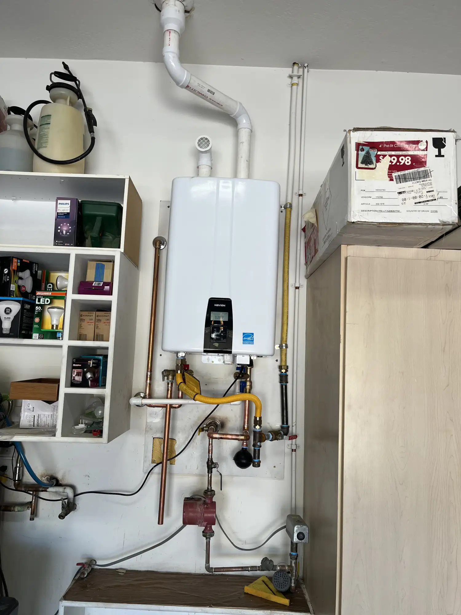 Wall-mounted tankless water heater providing on-demand hot water.