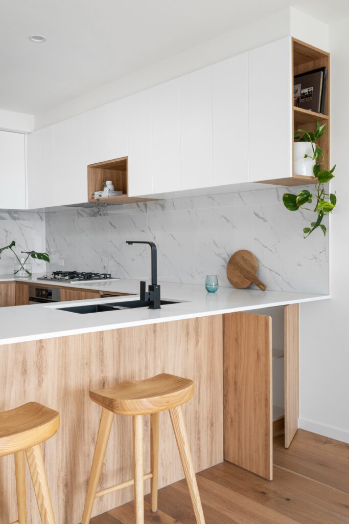 A bright, modern kitchen with stainless steel appliances and a large center island.